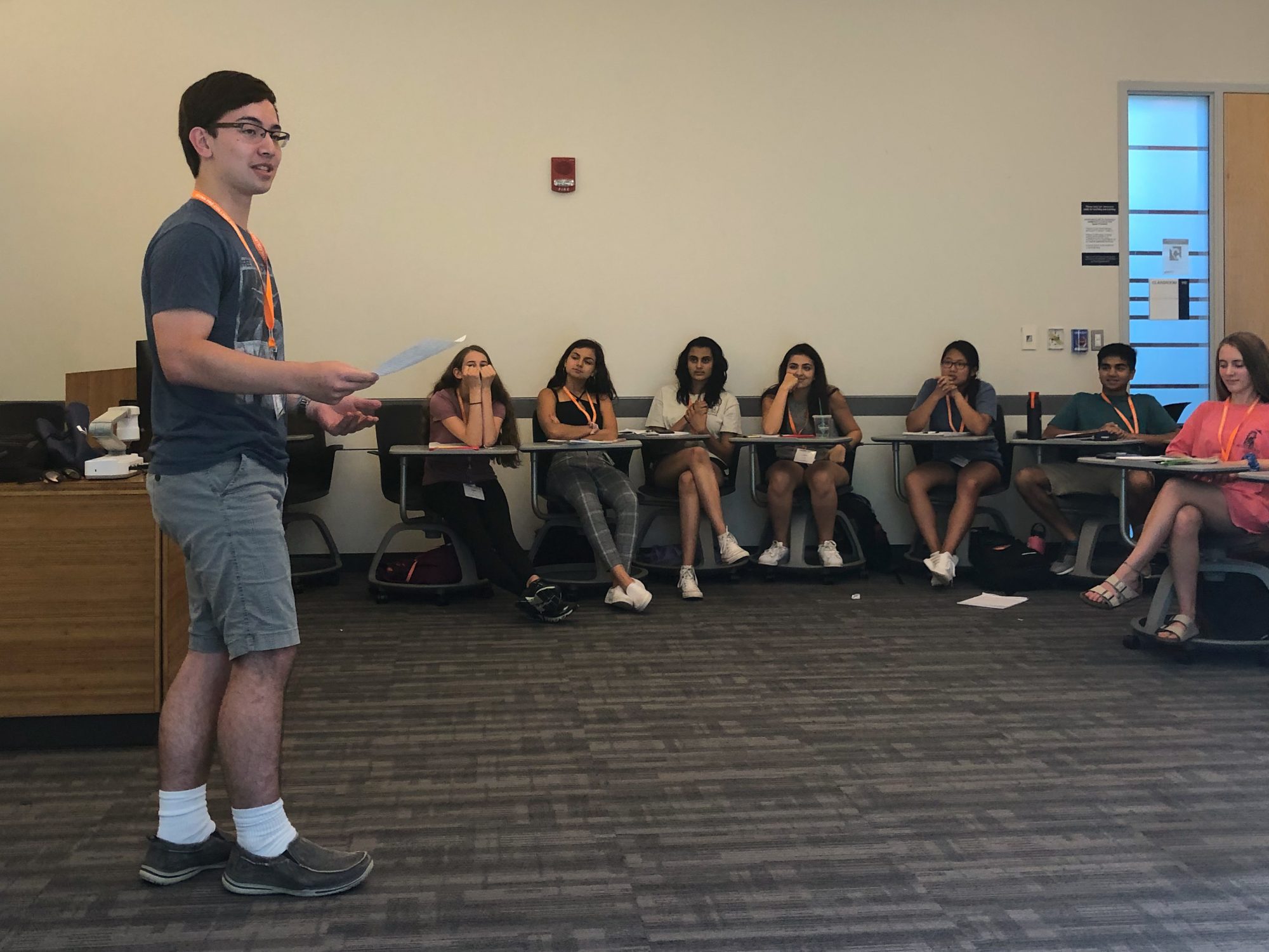 student standing in front of classroom with peers